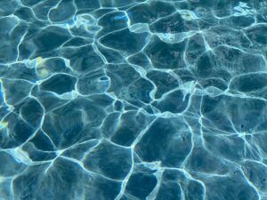 Blue Ripples and reflections in a swimming pool . Chlorine is in short supply during the pandemic.